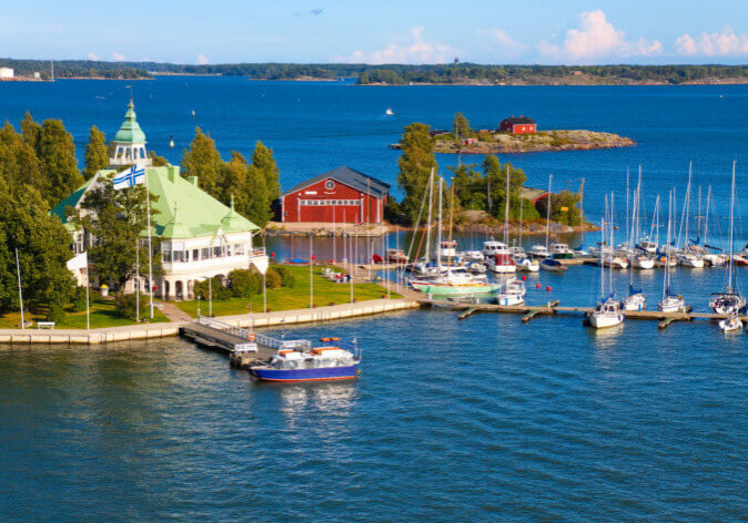 Rundreisen nach Finnland, Helsinki. Hafen mit Segelbooten und dem historischen Pavillon von Mariehamn auf den Åland-Inseln, Finnland, umgeben von blauem Meer und kleinen Inseln.