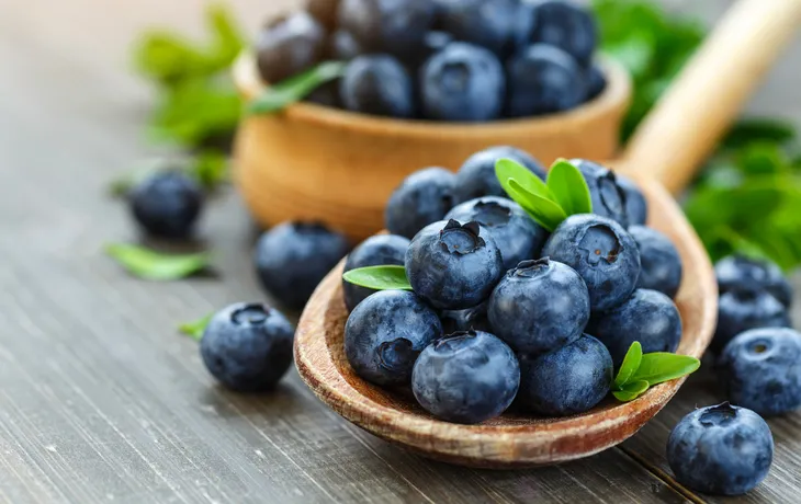 Fresh blueberries background with copy space for your text. Blue