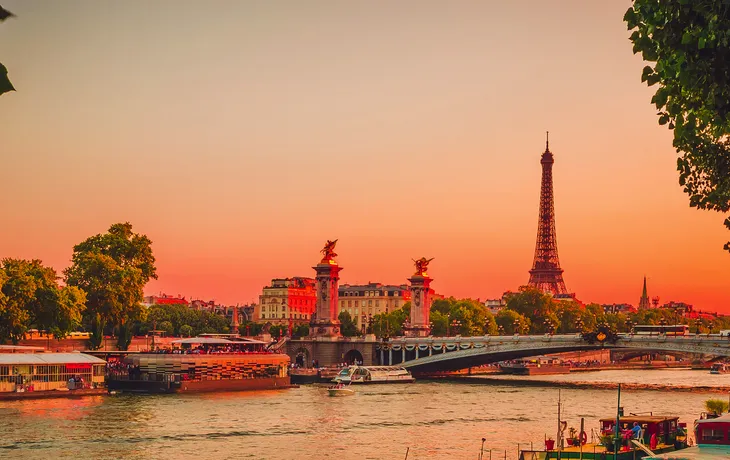 Sunset view of  Eiffel Tower, Alexander III Bridge and river Sei